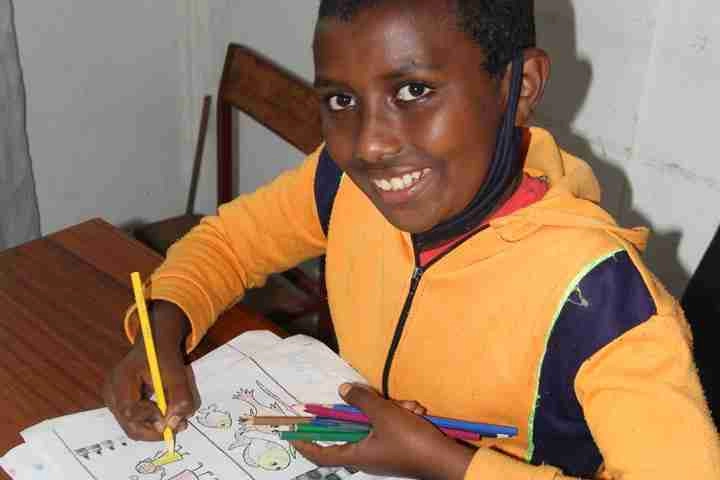 Abraham colouring in a book