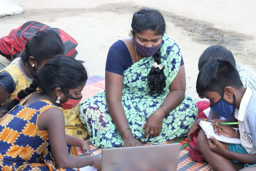 Students studying from a Laptop with masks