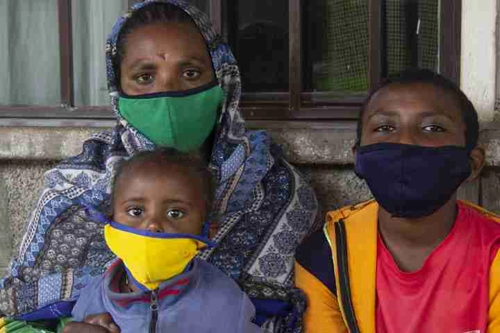 Abraham with his mother and younger sister wearing mask.
