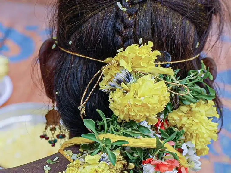 Back of the head of the girl wearing flower in her hair
