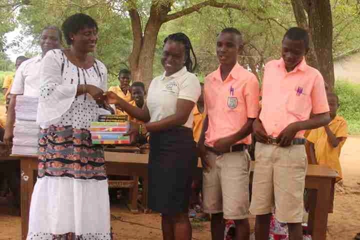 Children Believe’s Christelle, director of West Africa, presents children with books following an academic competition