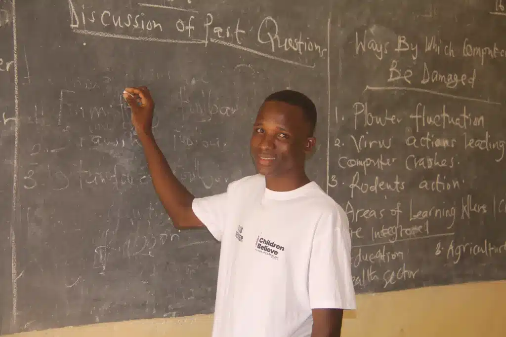Mohammed writing on a Chalkboard