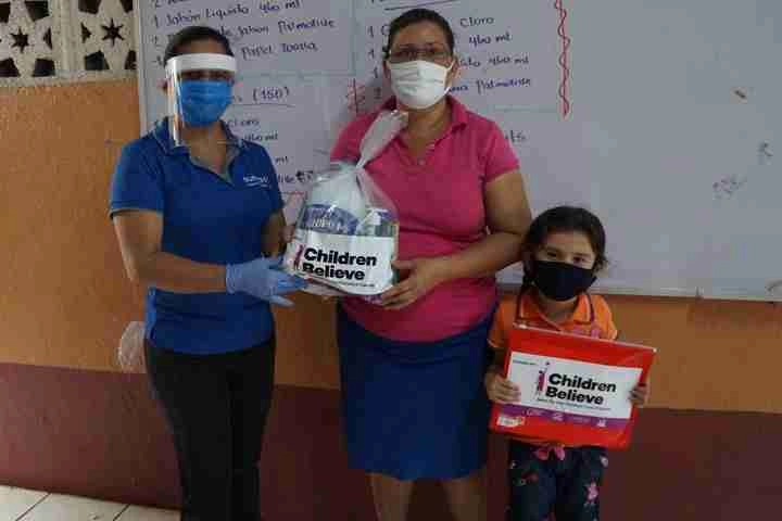 Women with her child holding a package from children believe