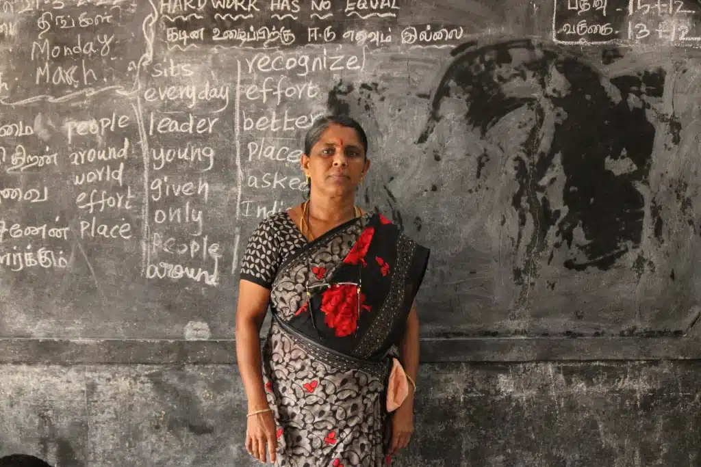 Picture of headmistress infornt of blackboard
