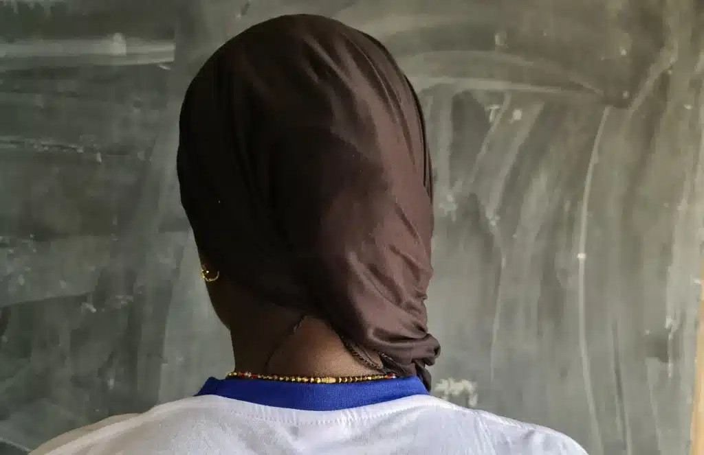 Dressed modestly in a T-shirt, skirt and black headscarf, Mounia