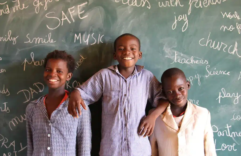 Boys standing in front of Chalkboard