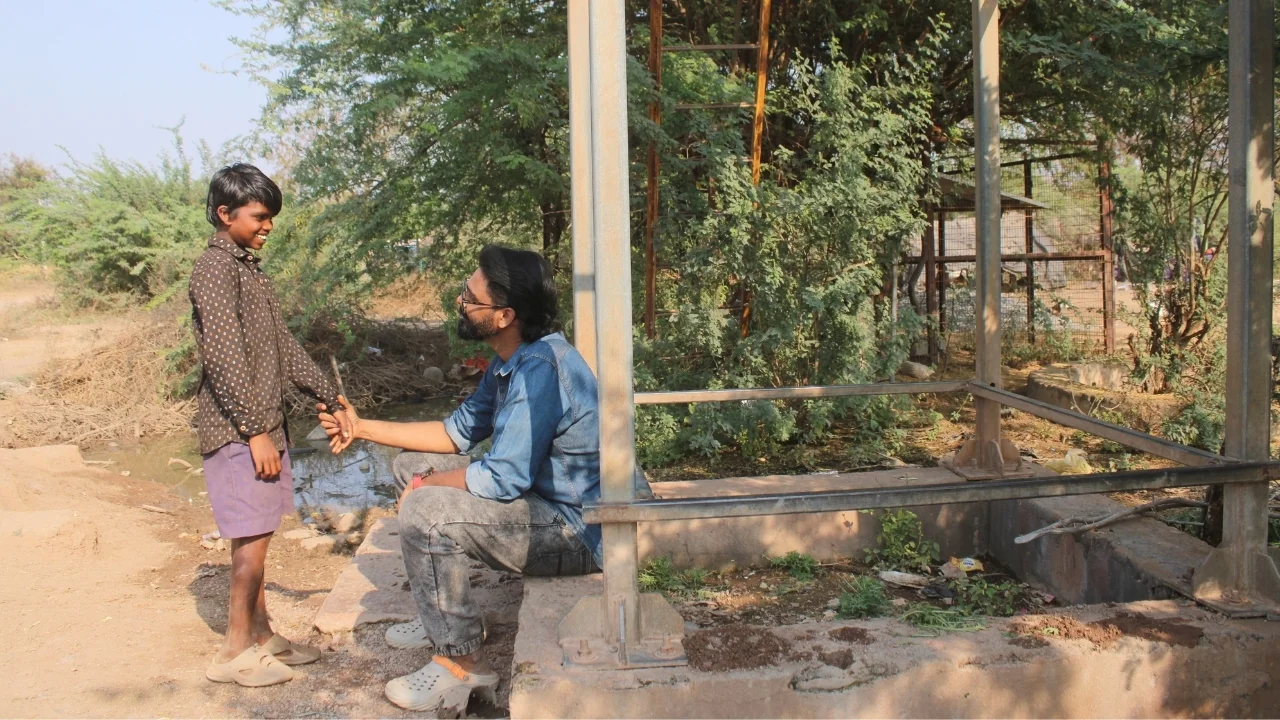 Speaking with a young boy in Allipalem